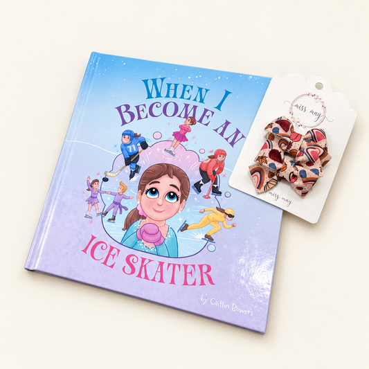 Hardcover copy of When I Become an Ice Skater by Caitlin Bowers with a pair of pumpkin floral rainbow bows on a display card resting over the book.