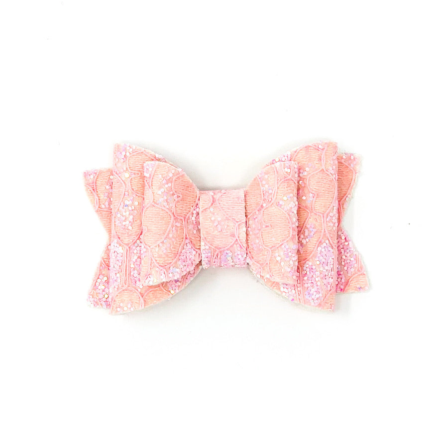 Pastel lace faux leather glitter bow in soft pink on baby girl outfit