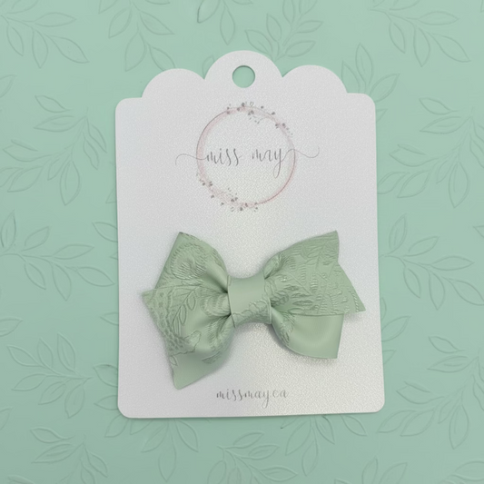 Soft green embossed faux leather bow clip, soft neutral toddler and girls hair accessory