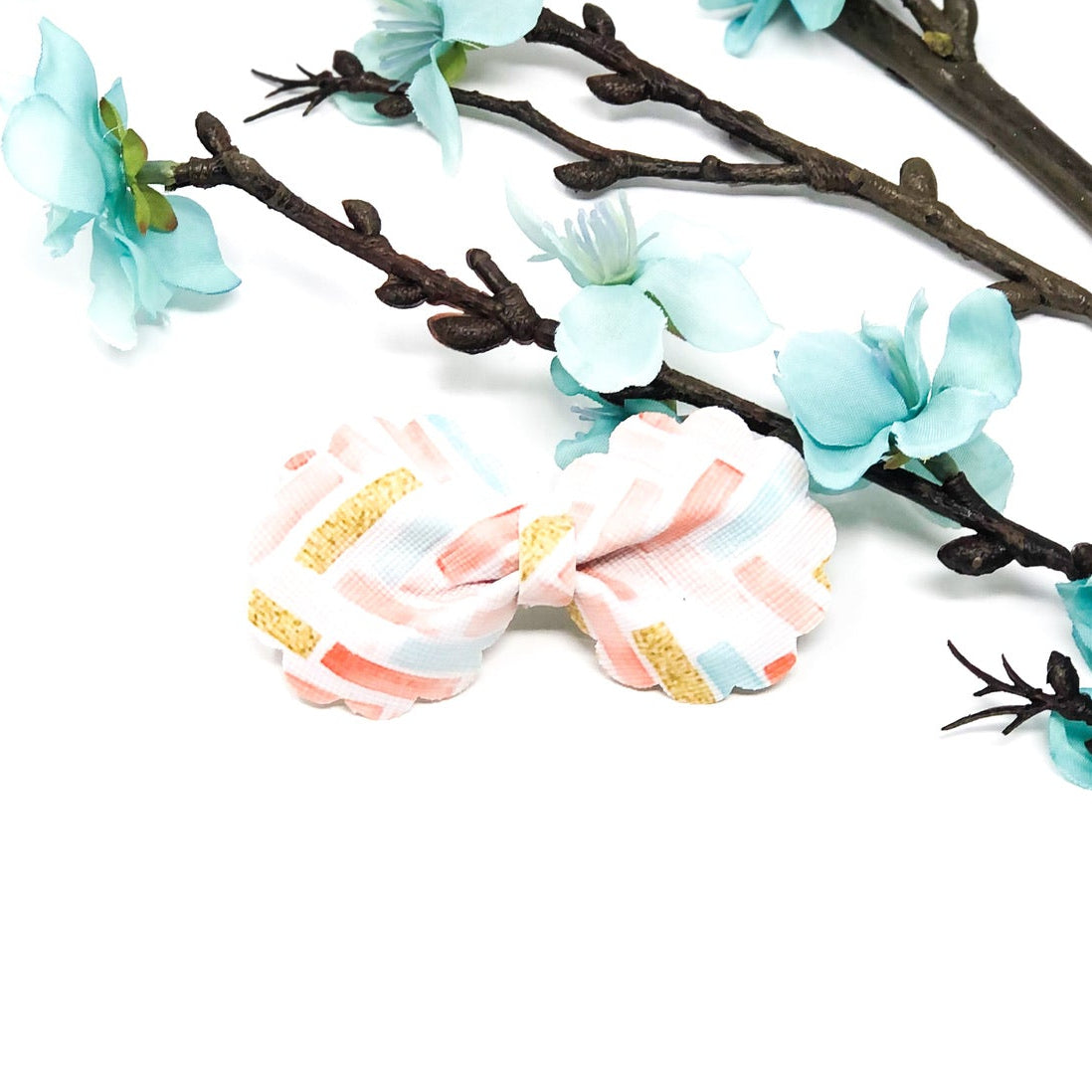 Ruffle Bloom Bow Collection handmade ruffle flower hair bows in coral pink, dusty blue, and spring zigzag pattern