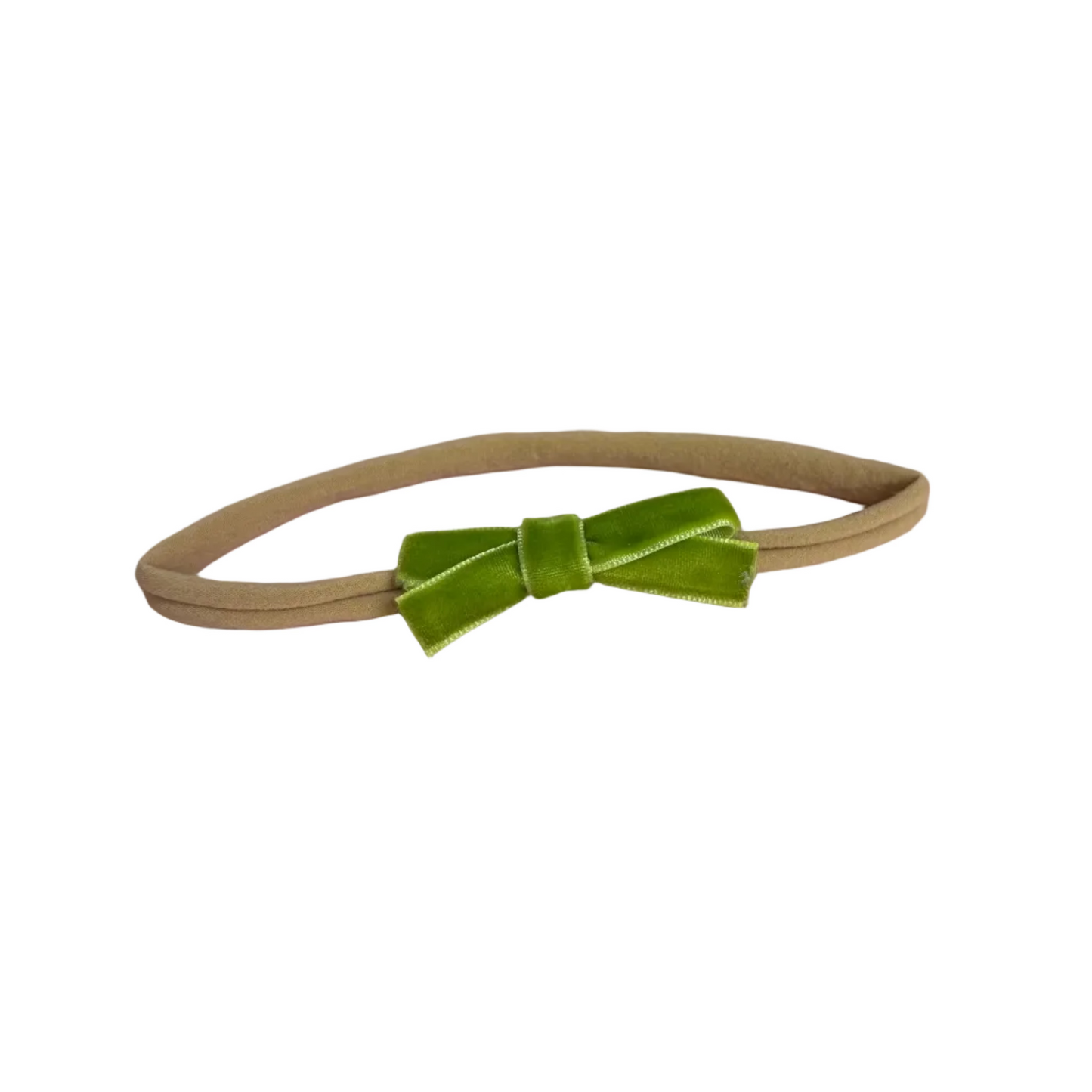 Beige headband with a green velvet bow on a white background